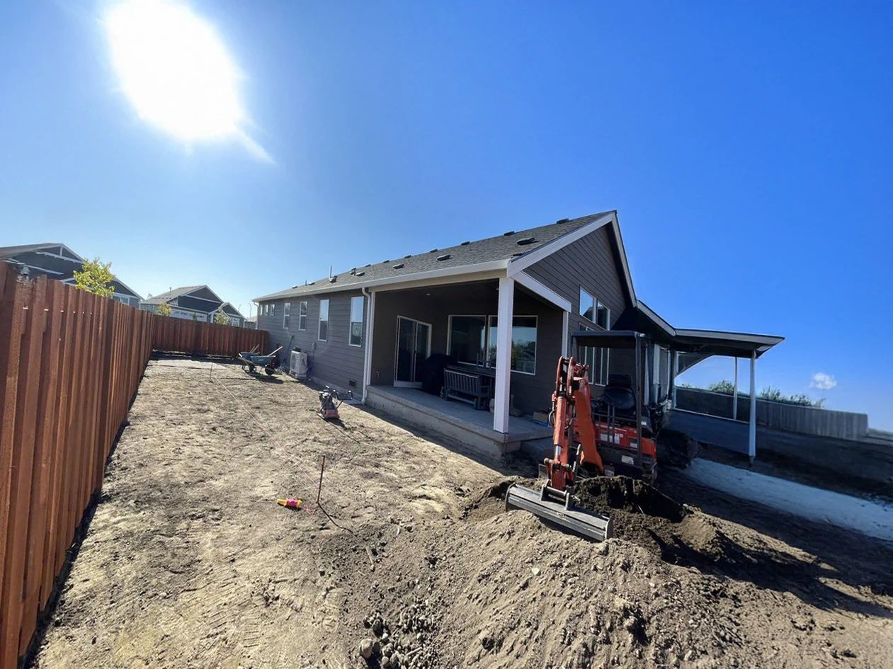 Backyard before the paver transformation, with the site excavated and awaiting installation.