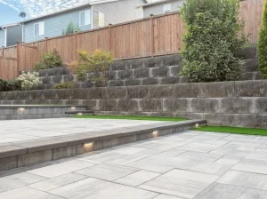 Paver patio with low retaining walls and built-in lighting.