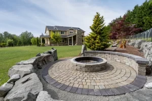 Circular fire pit built into a paved outdoor living area.