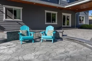 Covered paver patio with bright outdoor lounge chairs.