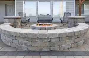 Circular stone fire pit with built-in paver seating.